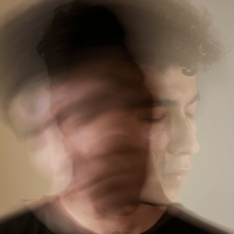Blurred image of a man with closed eyes, representing the calming and stress-relieving effects of Ashwagandha for mental clarity, featured on Zaira Natural.