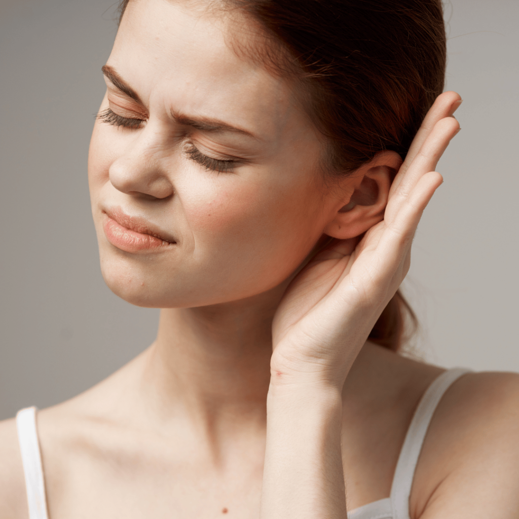 Woman experiencing ear pain, representing the natural relief provided by Mullein Flower (Verbascum thapsus) for ear infections.